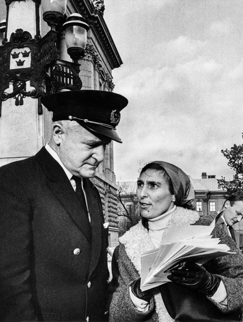 Året är 1967. Katarina Taikon delar ut flygblad framför riksdagshuset, men stoppas av vaktmästaren. Foto: John Kjellström/SvD/TT.
